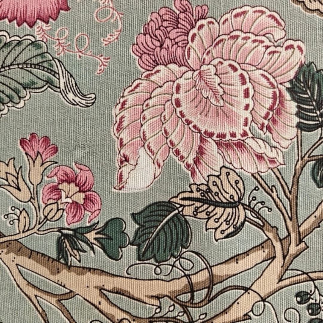 Close-up of pink floral print on sage green fabric